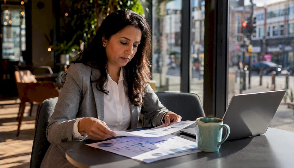 Business leader reviewing AI trends at office table