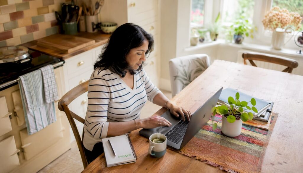Woman replying to Google reviews on laptop
