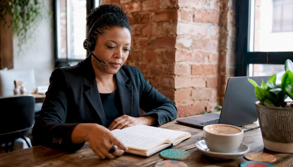 Woman using AI receptionist headset at desk