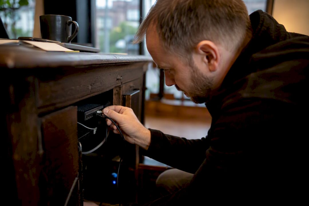 Hand plugging in business router cable