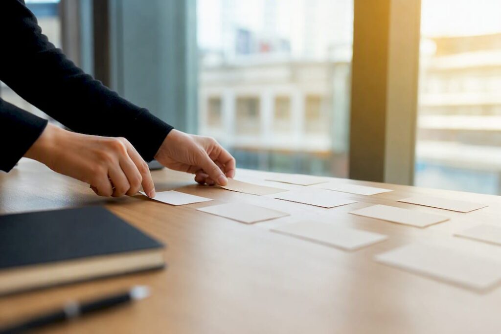 Hands arranging SEO strategy cards
