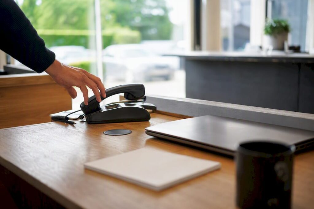 Hand picking up phone for local services call